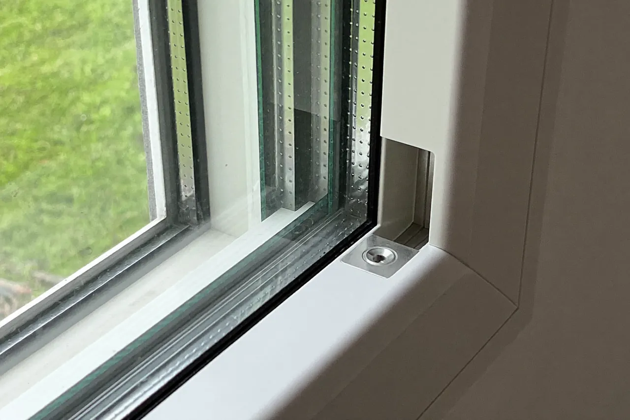 Edge detail of a triple-glazed window showing three panes